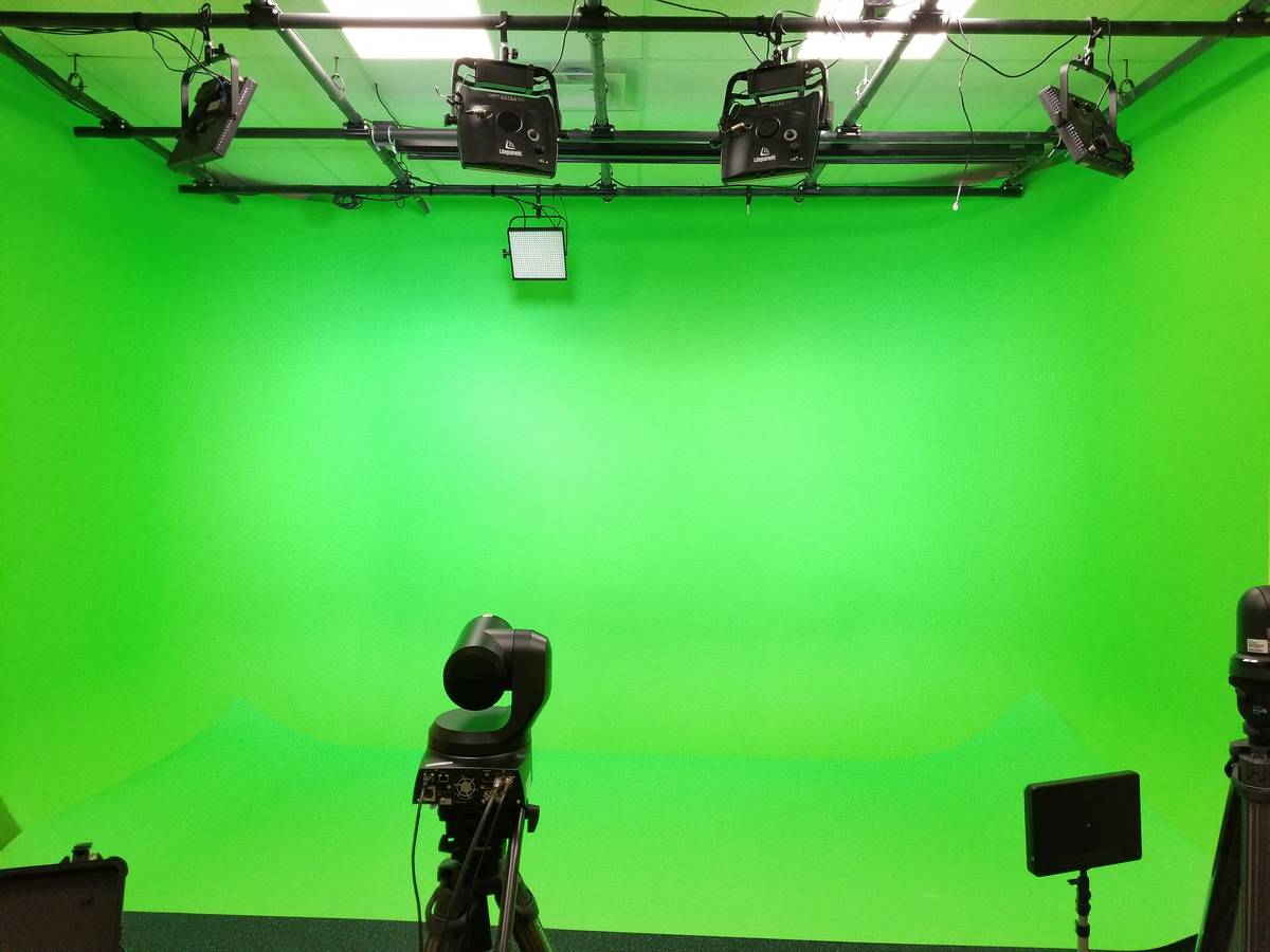 A PTZ camera on the studio floor, cyc lit behind