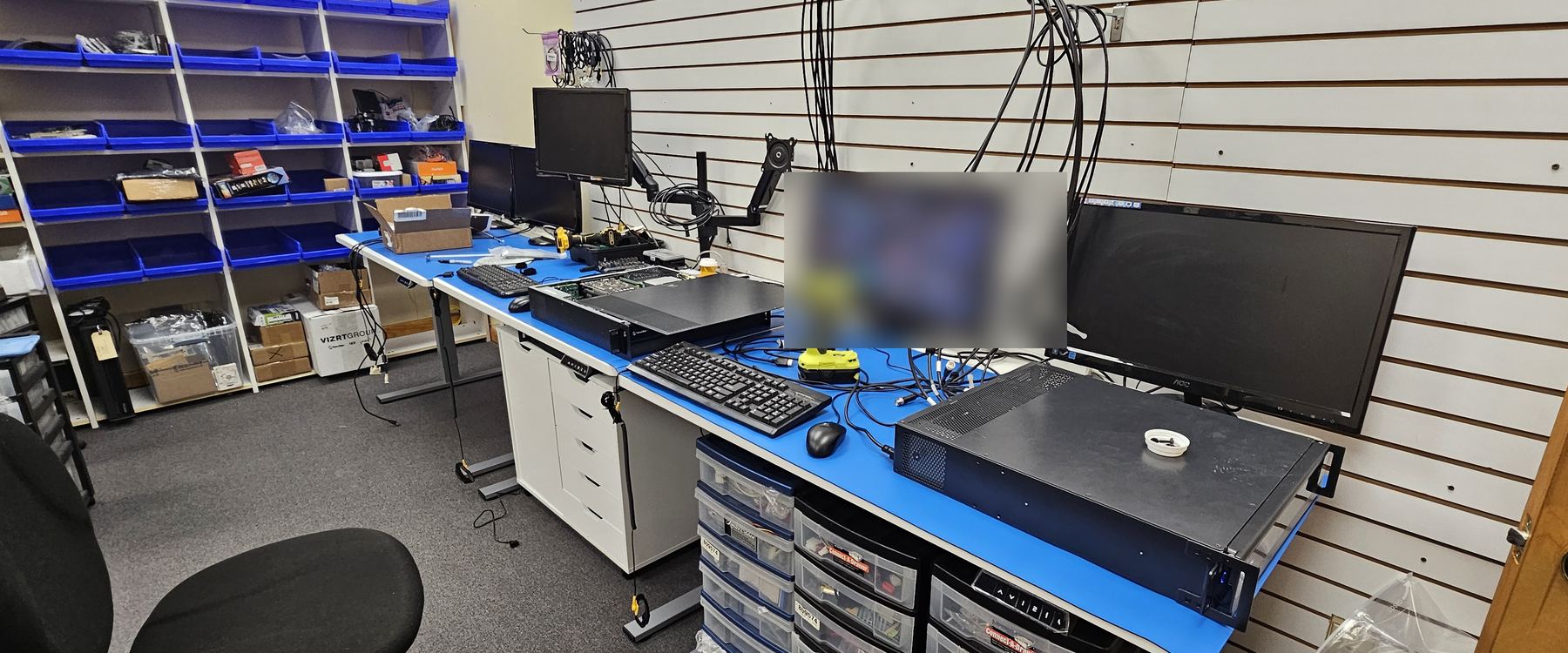 The Varto service bench in East Rutherford, parts bins, test monitors and a system opened for diagnosis