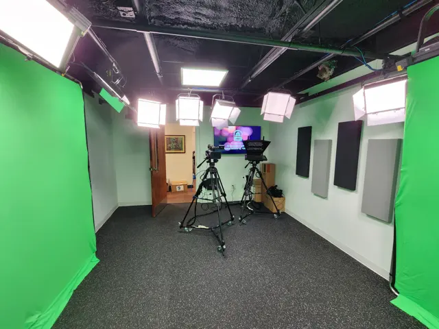 The Karjian Hairenik Media Center studio floor: green-screen walls, overhead lights, a prompter and a camera