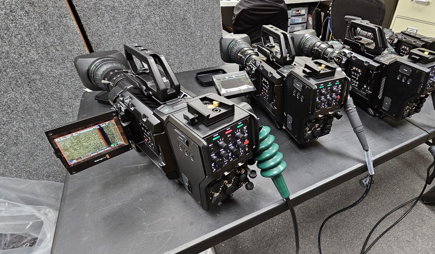 Three Blackmagic URSA Broadcast G2 cameras with B4 lenses and a viewfinder on a work table in Varto’s shop