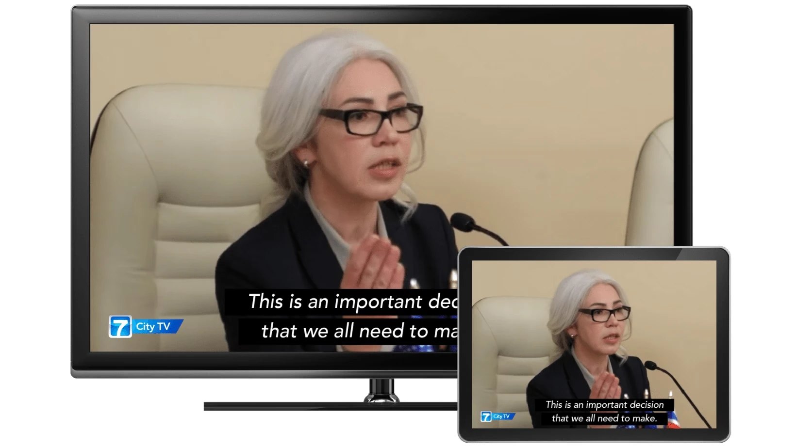 The same council meeting with closed captions on a television and a phone