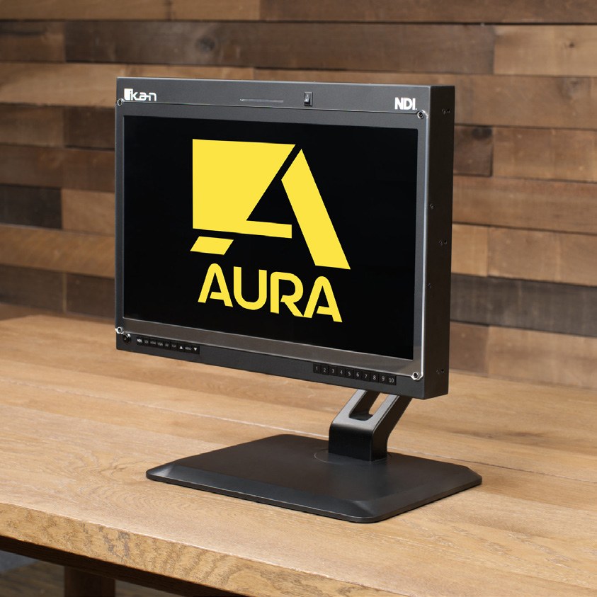 Ikan Aura 19-inch NDI monitor on a stand on a desk, with an NDI badge on the bezel