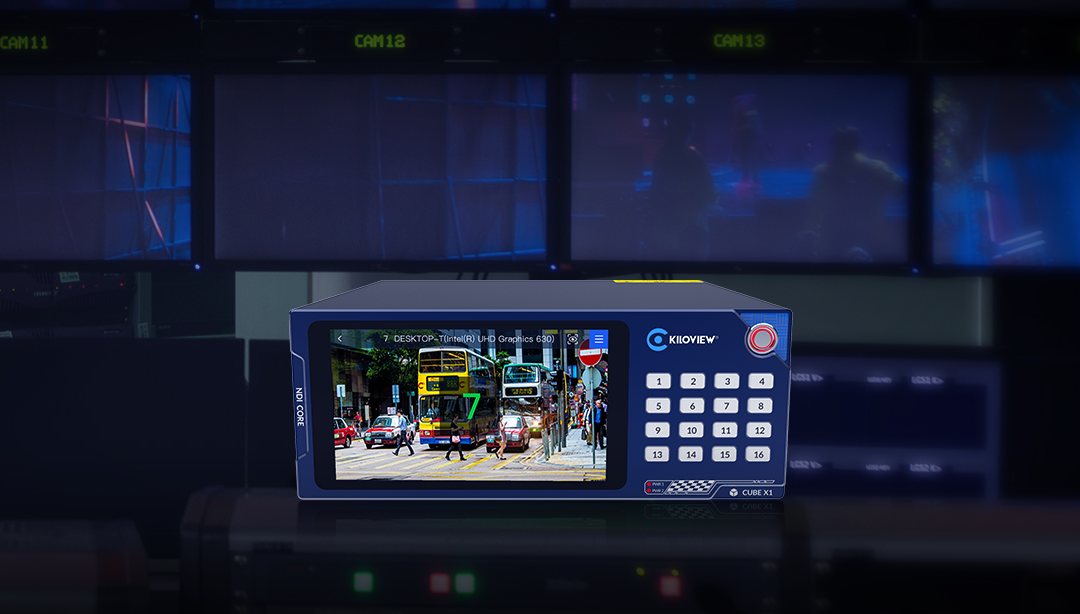 Kiloview CUBE X1 with a touchscreen and button keypad in front of a monitor wall