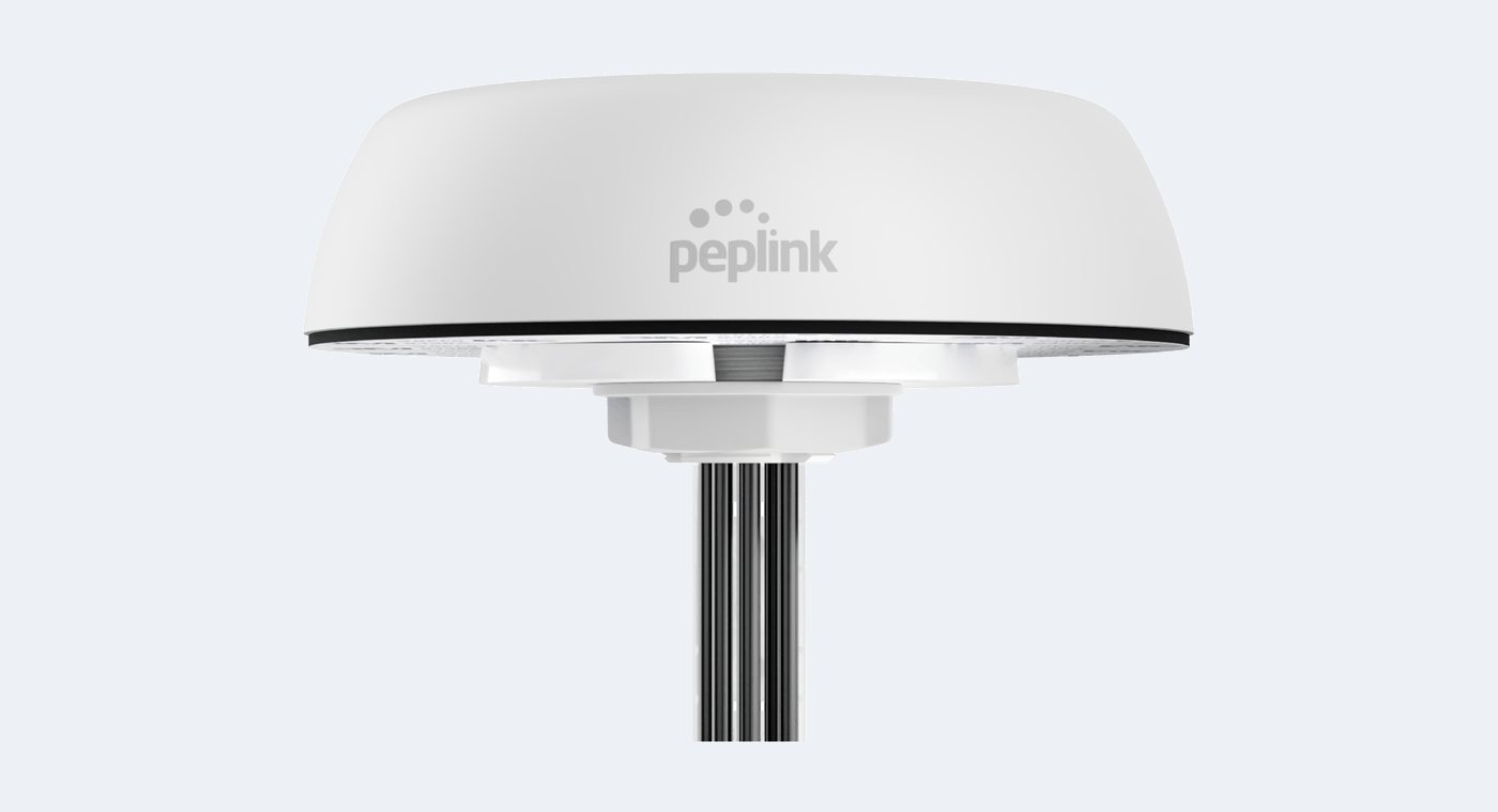 A Peplink Mobility roof-mount vehicle antenna, a white dome with its cable leads