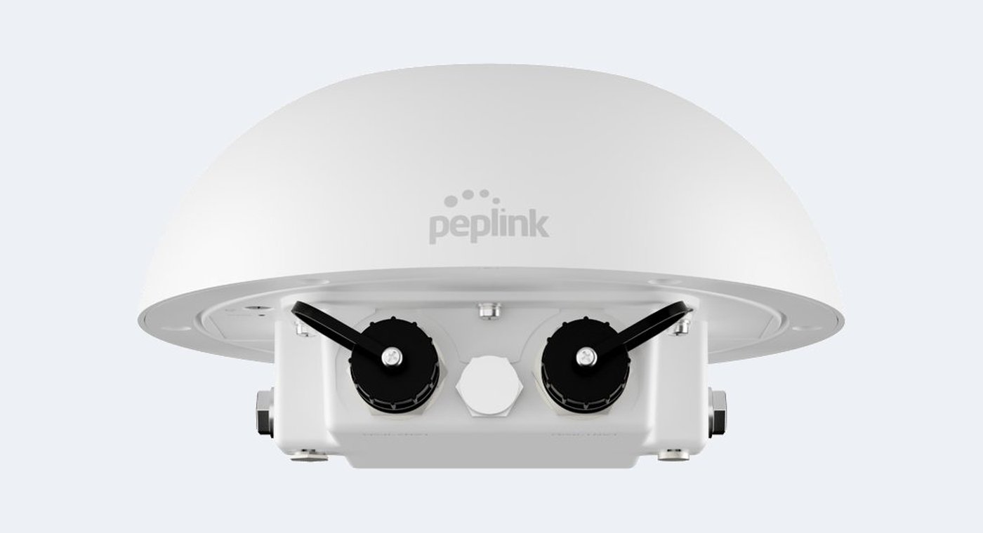 A Peplink MAX HD1 Dome Pro outdoor router in a white weatherproof enclosure