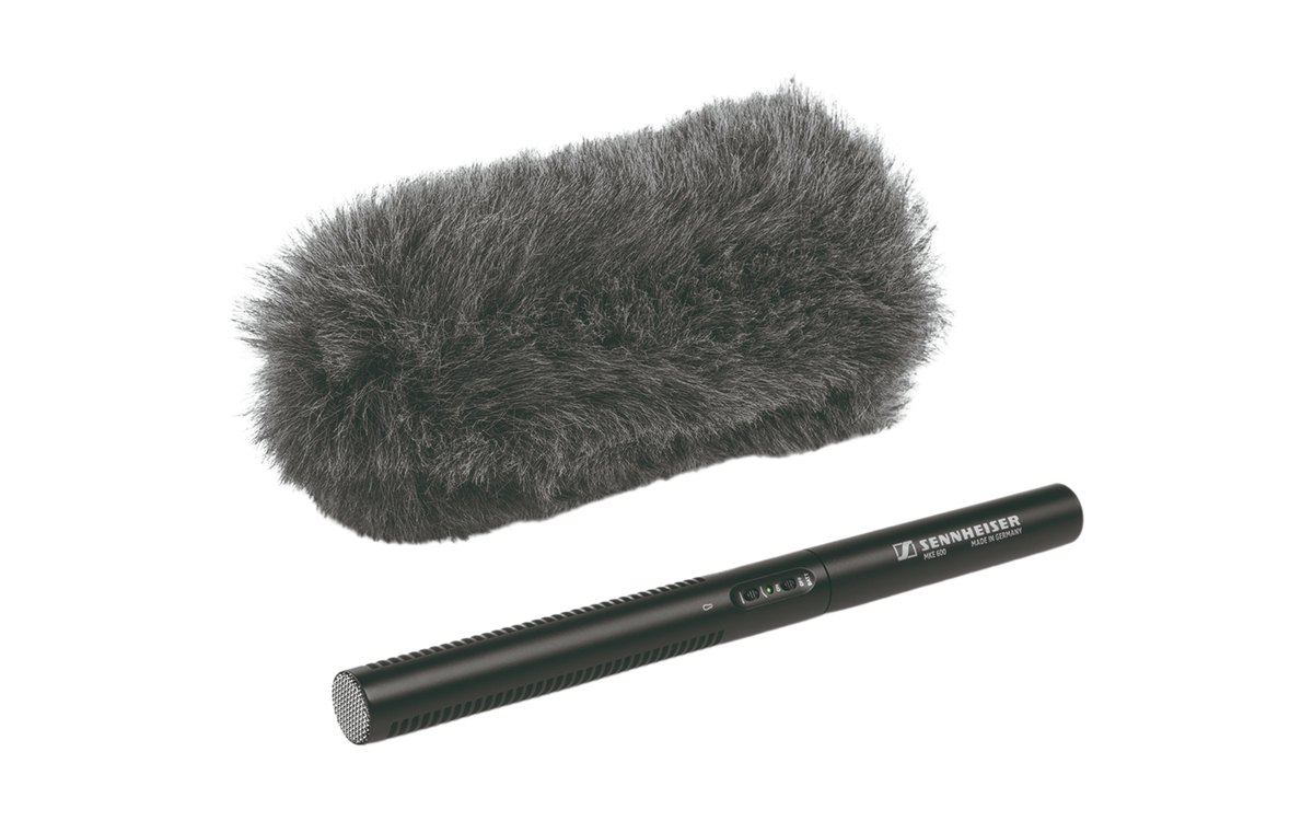 A Sennheiser MKE 600 shotgun microphone beside a furry windshield