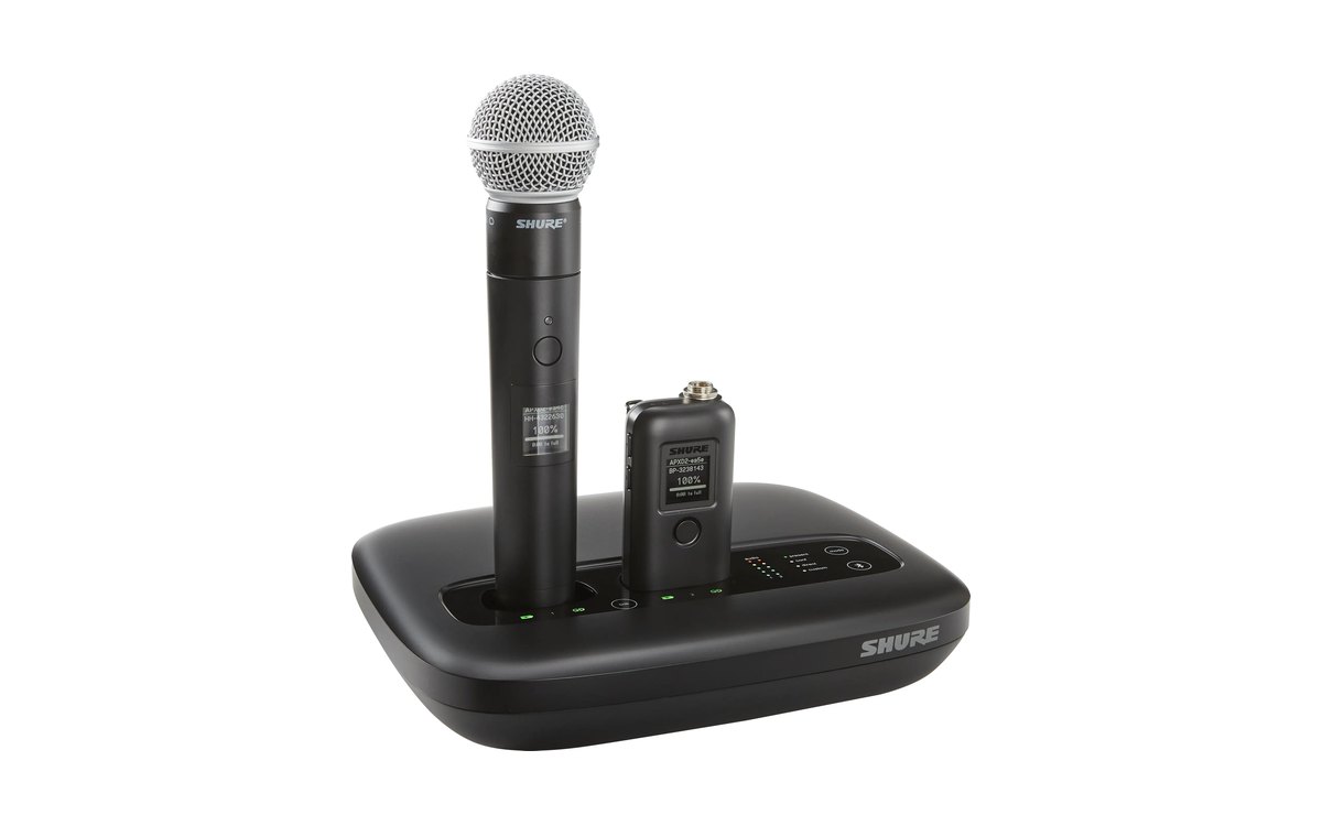 A Shure MXW neXt 2 tabletop access point charging a handheld and a bodypack transmitter