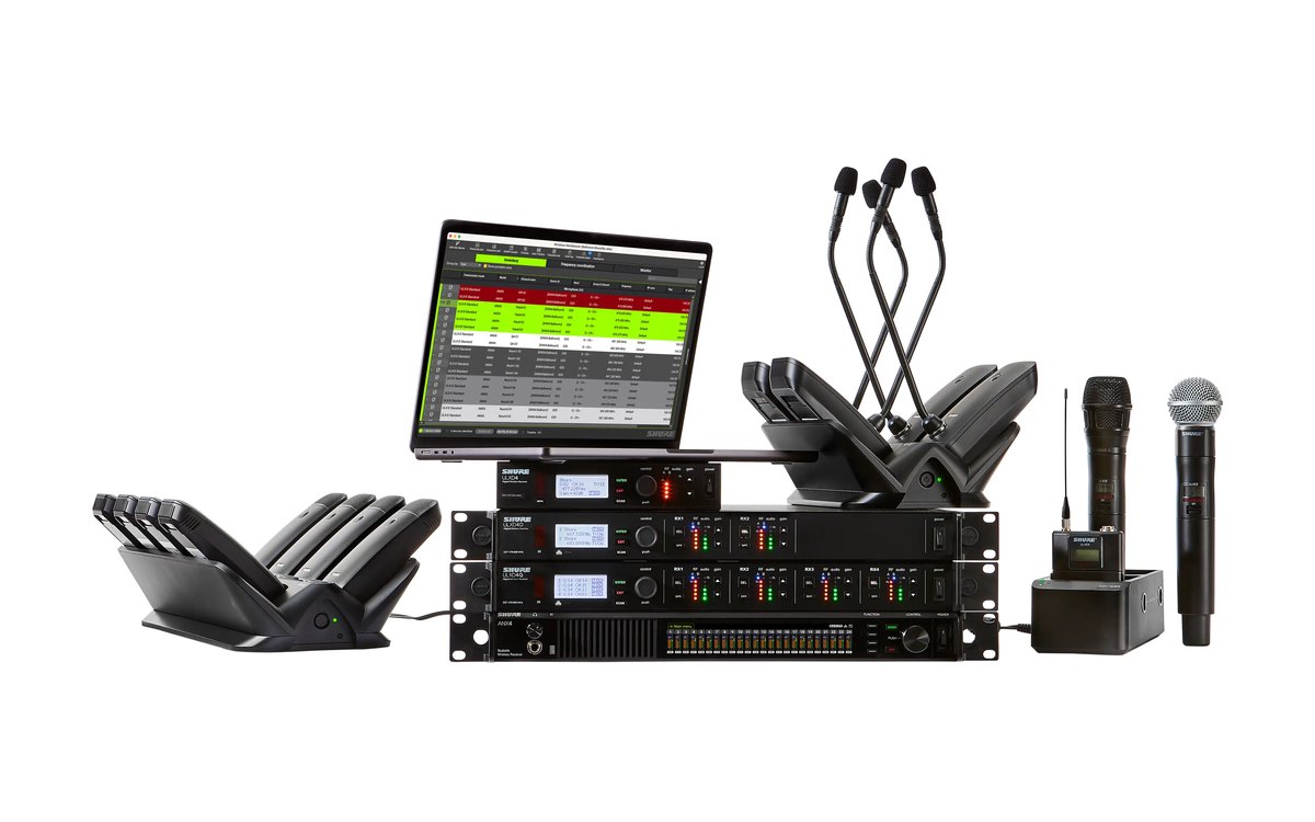 Shure ULX-D receivers with gooseneck, boundary and handheld transmitters and Wireless Workbench on a laptop