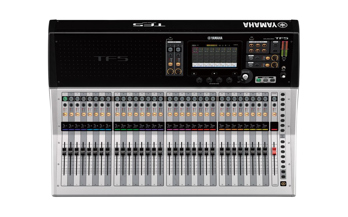 A Yamaha TF5 digital console seen from above, with 32 channel faders and a master