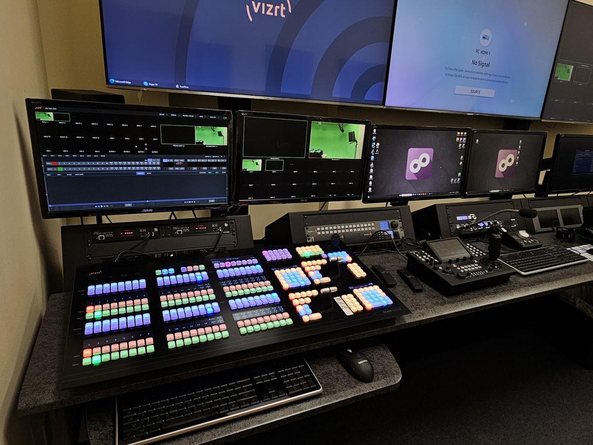 Control room surfaces and monitors, with Vizrt systems on the screens