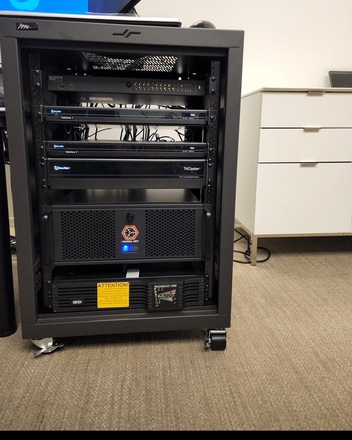 An equipment rack at The Washington Post holding a network switch, two TalkShow units, a TriCaster TC1, a media server and a UPS