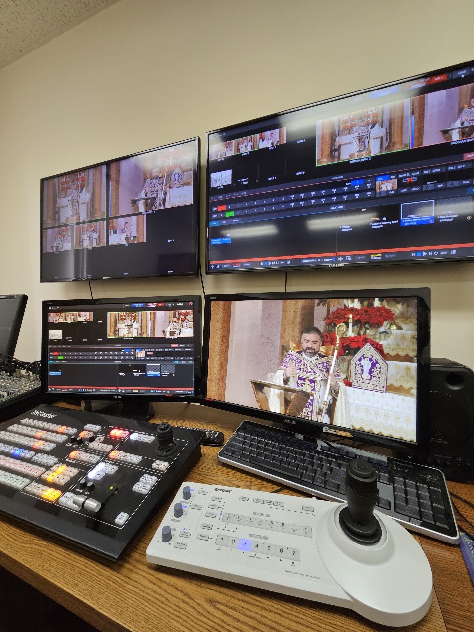 The streaming control position at St. Vartan Armenian Cathedral: a TriCaster control surface, a PTZ camera joystick controller and monitors carrying the liturgy