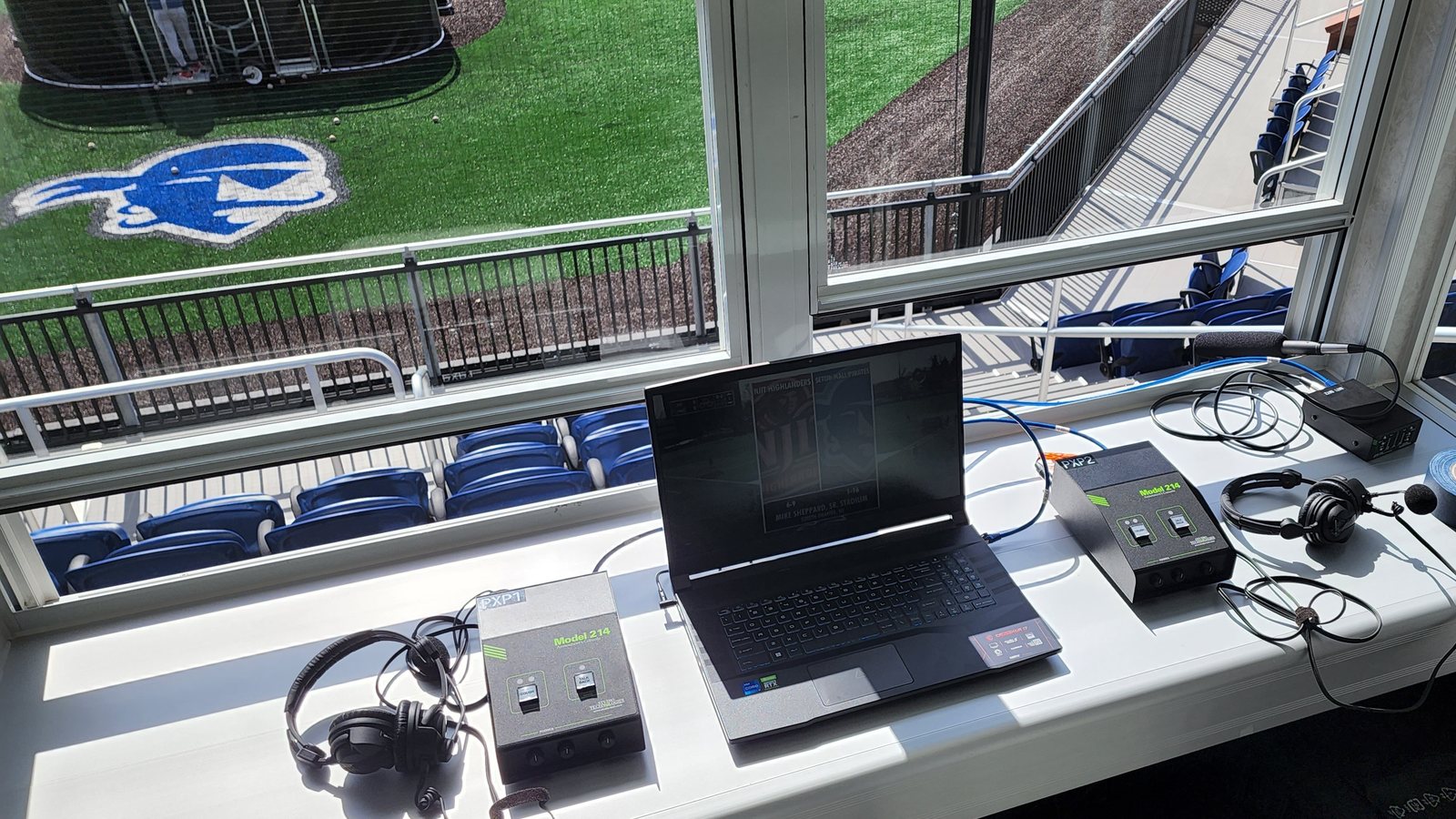 Announce position above a college baseball field, two consoles and headsets ready