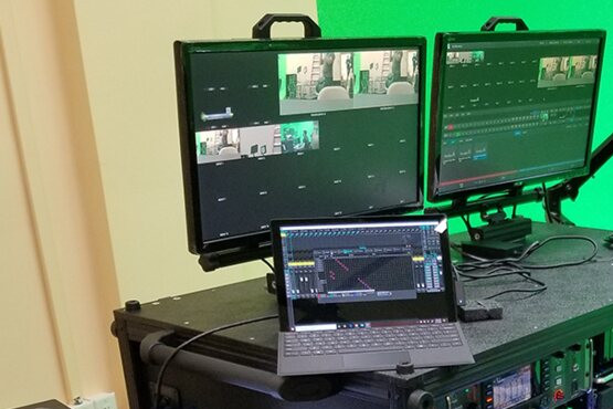 A streaming flypack: two preview monitors and a laptop on top of the rack