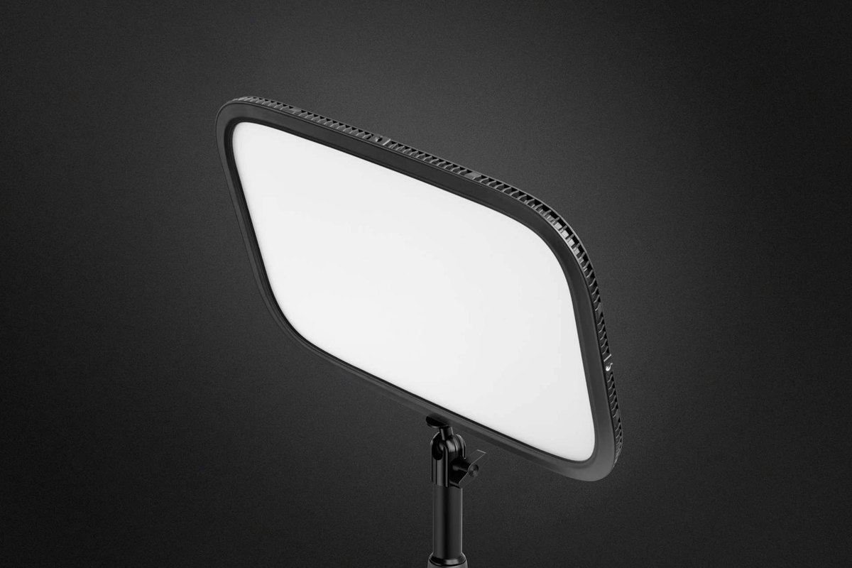 An Elgato Key Light panel lit white on a stand, on a dark background