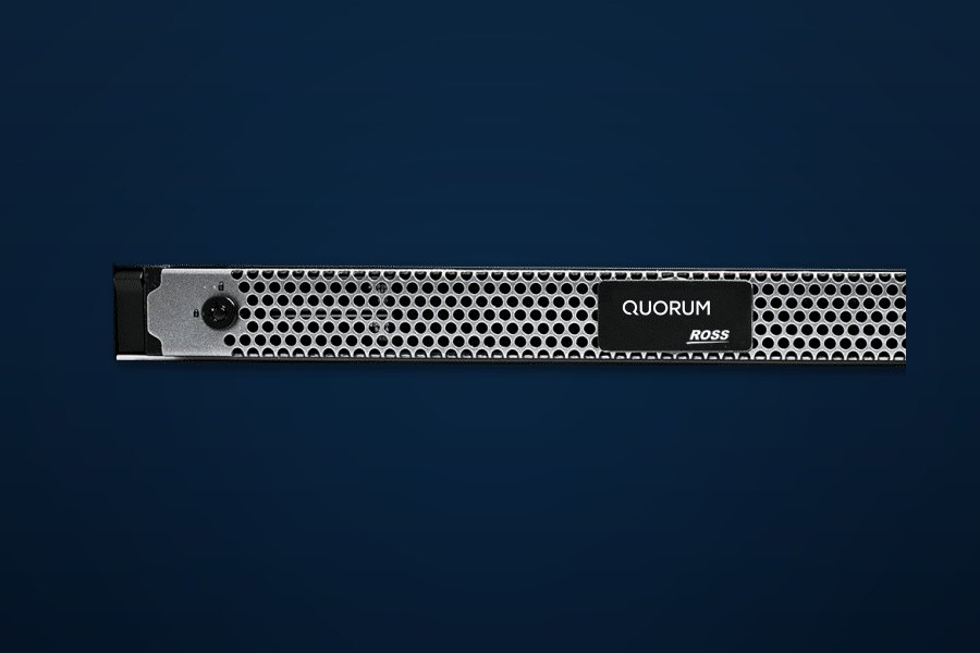A Quorum 1RU server front panel with a perforated grille and the Quorum and Ross logos, on a dark blue background