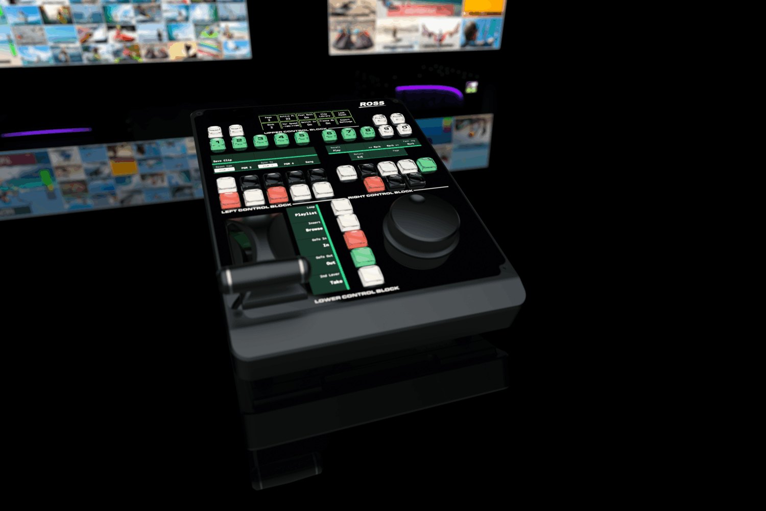 A Rio Replay control panel with a lever, a jog wheel and lit buttons in a dark room below replay monitors